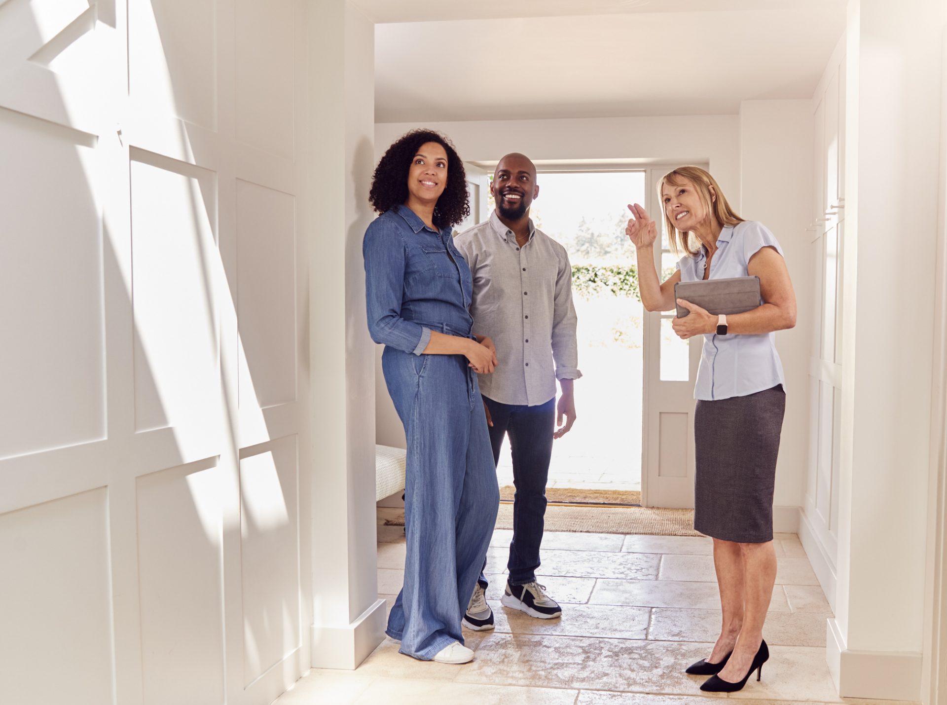 Couple Viewing Potential New Home With Female Real Estate Agent