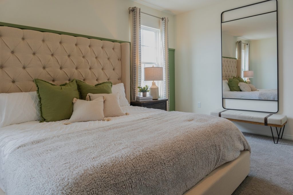 Sweet Dreams: A Guide to Refreshing Your Bedroom. Luxury master bedroom with tufted upholstered headboard with window and night stand