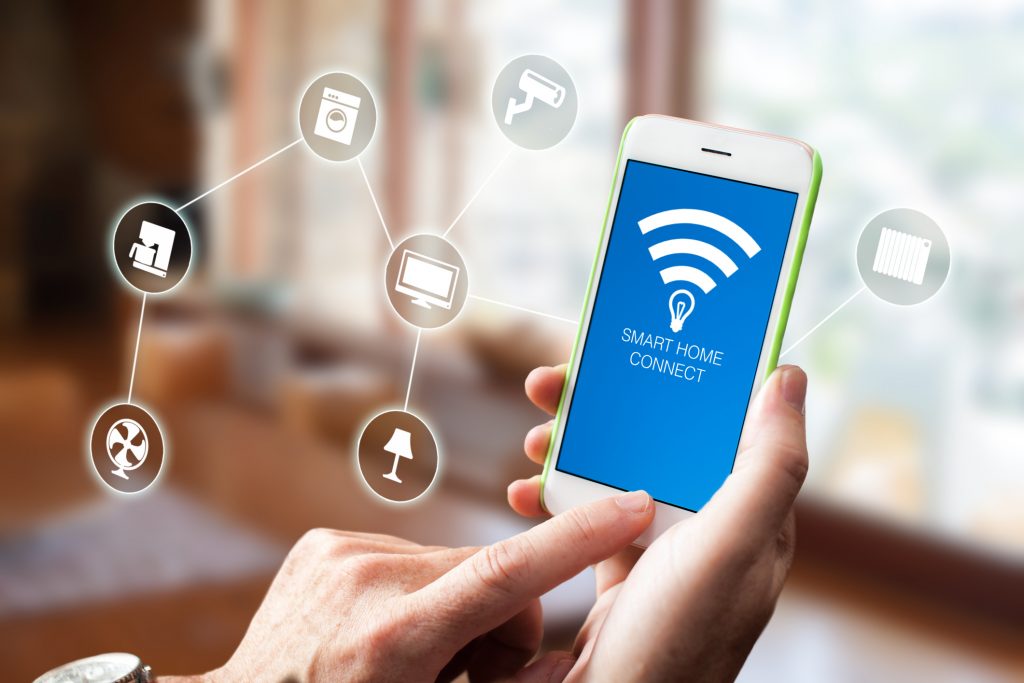 How to Set up Your Smart Home. Man using smart home app on smartphone. Smart home, house automation remote control concept.