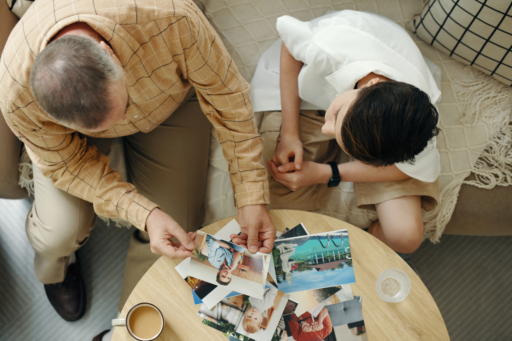Granddad Showing Family Album To Grandchild