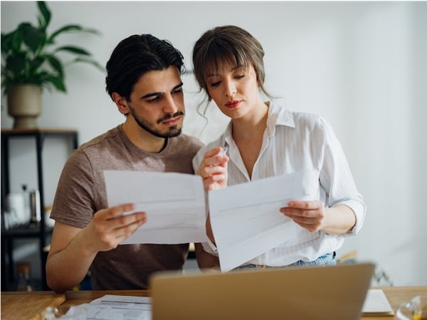 Couple reading over warranty documents together.