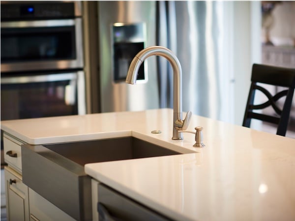 Kitchen with clean white countertops and elegant farmers sink