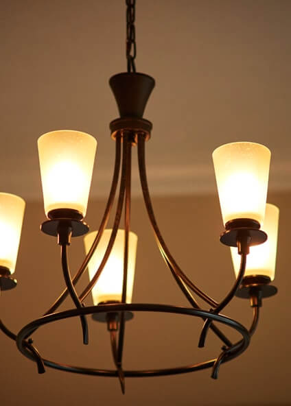 Circular foyer hanging light with five bulbs and upturned shades