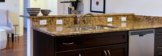 Granite kitchen countertop with raised bar overhang