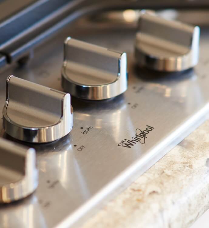 Whirlpool stainless steel cooktop - temperature knobs detail