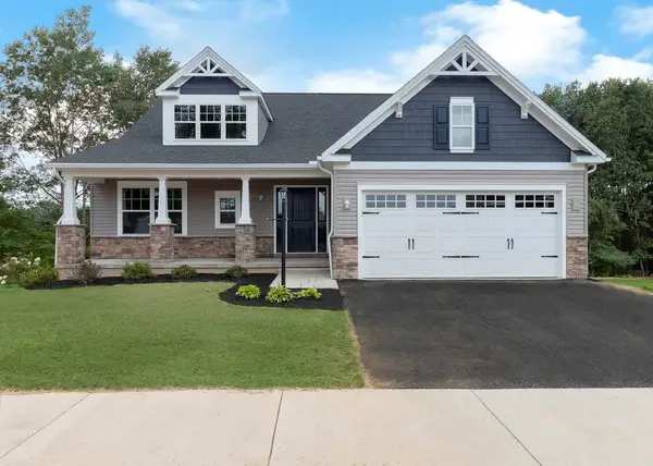 Craftsman-style Aspen home with mixed siding, stone accents, covered porch, dormer windows, and a two-car garage.