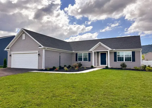 Coleford ranch-style home with horizontal siding, front-entry garage, covered porch, and fresh landscaping.