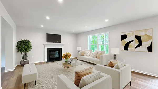Hawthorne family room with fireplace, large windows, recessed lighting, and staged furnishings.