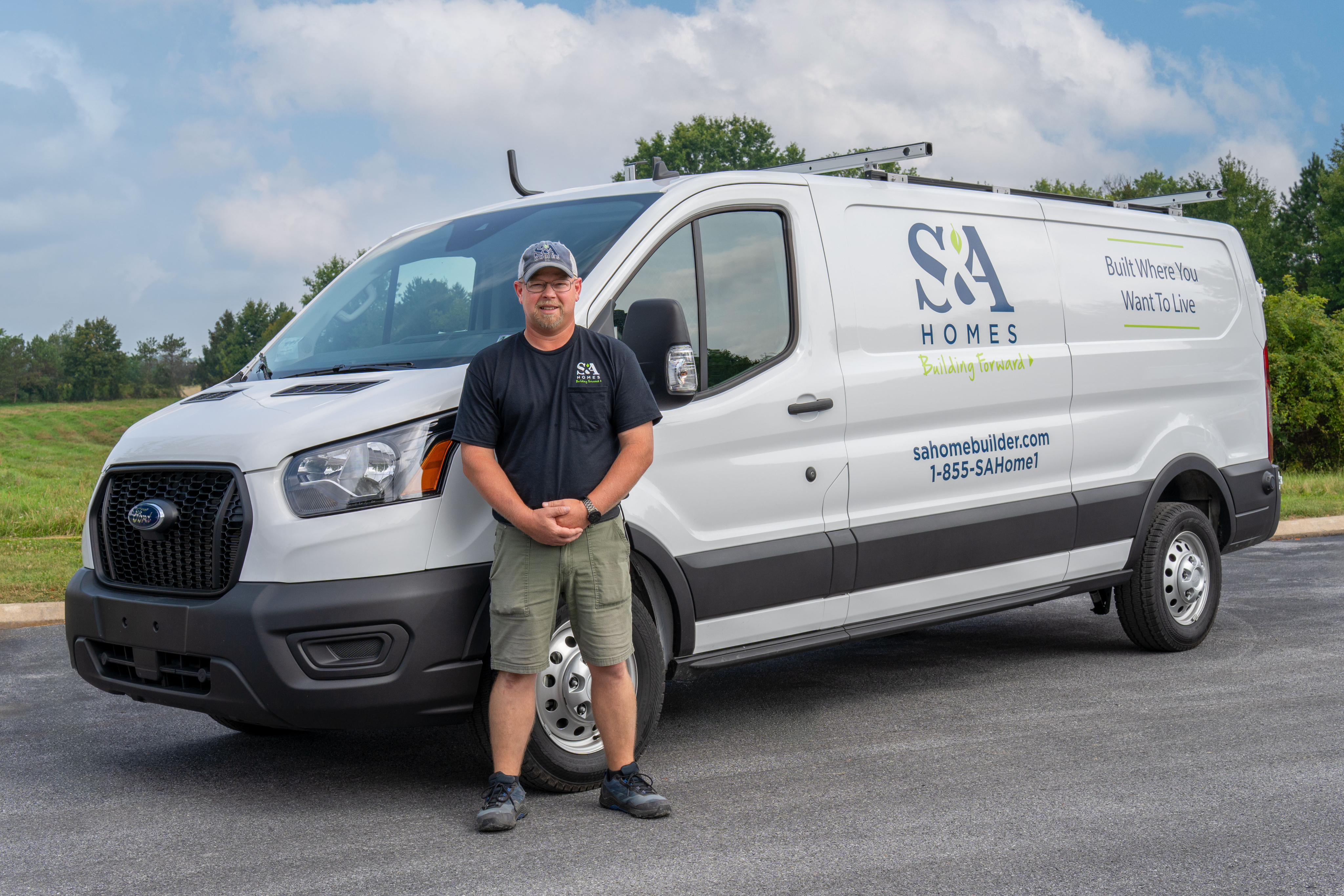 S&A Homes team member standing in front of a branded service van.