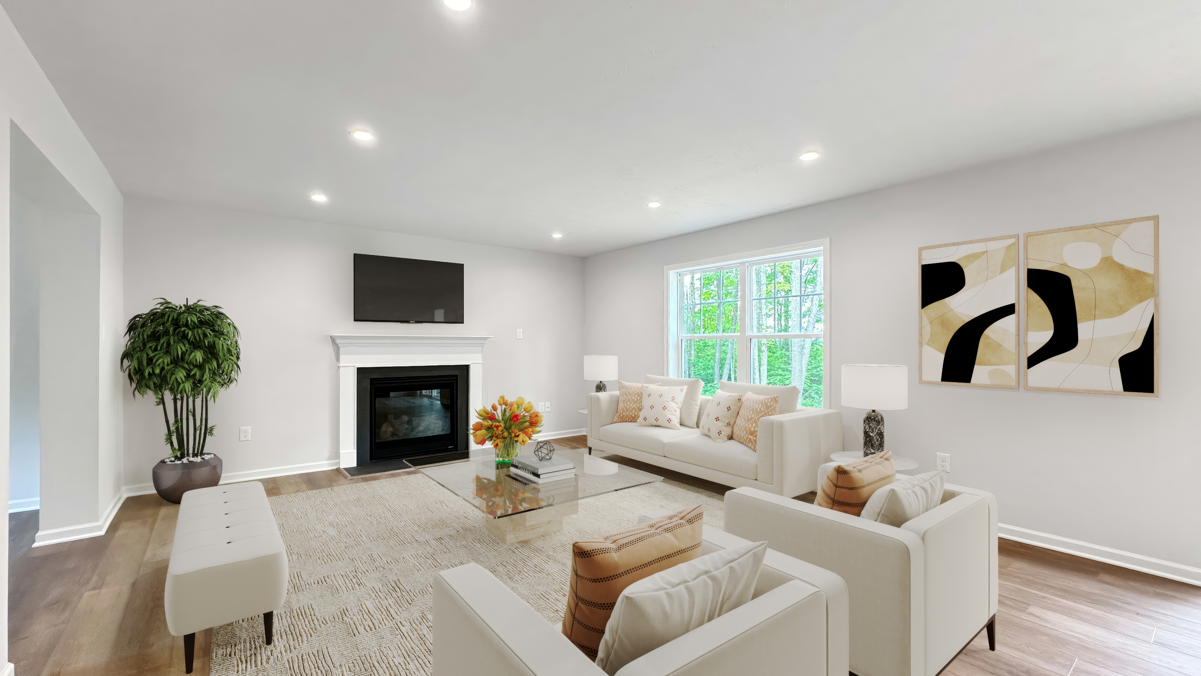 View of an inviting communal space with seating, fireplace, large window, abstract art on the wall.